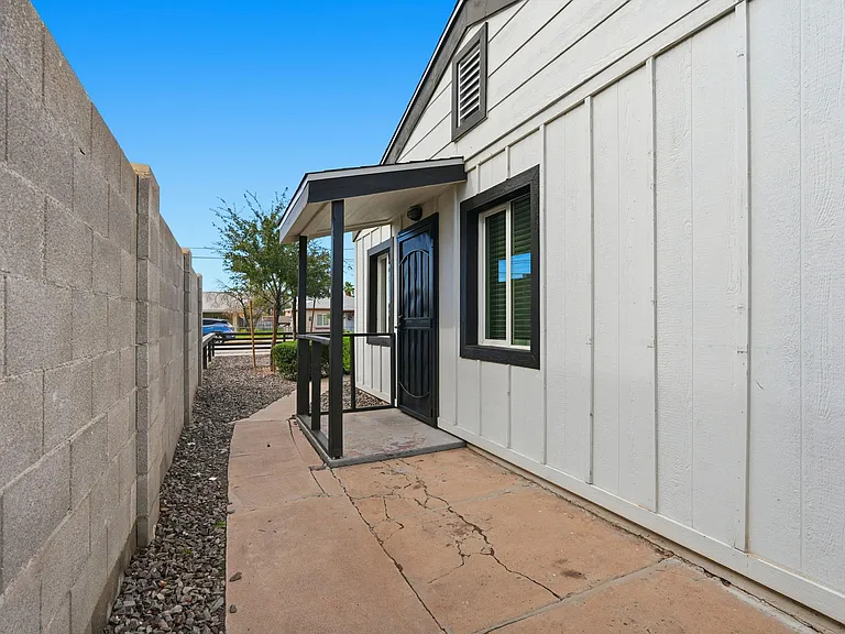 Side entrance that leads to back lot. Also covered with seating area to the side.