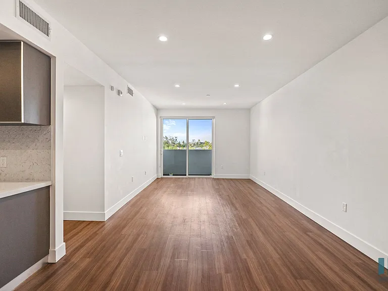 Living Room with Vinyl Flooring, Recessed Lighting, and Patio