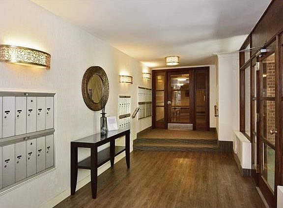 Mailbox area and just steps up to the main floor entrance on either side, and elevators