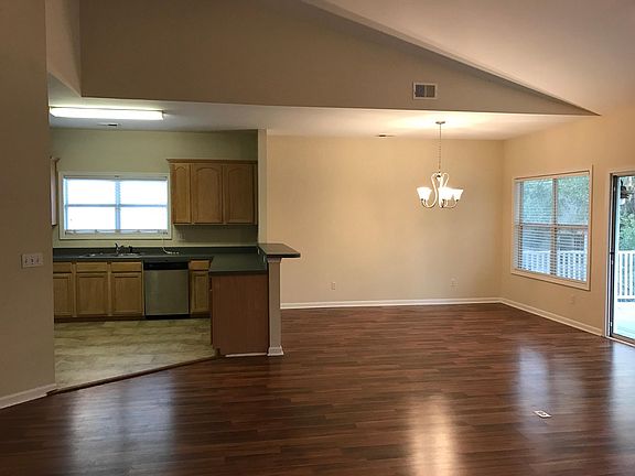 living room, kitchen & dining room with vaulted ceilings