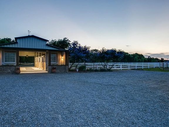 Charming 4 stall barn! 48' x 36' steel barn with front porch featuring beautiful rock flower beds. Stalls offer limestone base with rubber matting, swing out feeders, dutch doors and good ventilation.