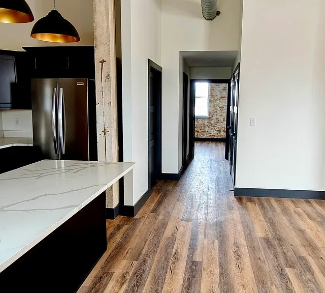 Hallway view: Utility closet on the right with washer/dryer. Second bathroom on the left and the guest bedroom at the end
