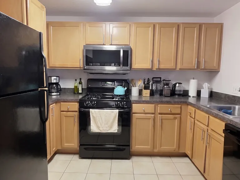 Large kitchen with fridge, microwave, oven, stove, and dishwasher plus lots of cabinets & counter space