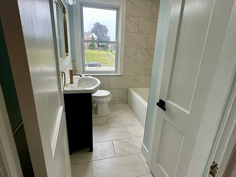 Newly Renovated Bathroom with storage closet
