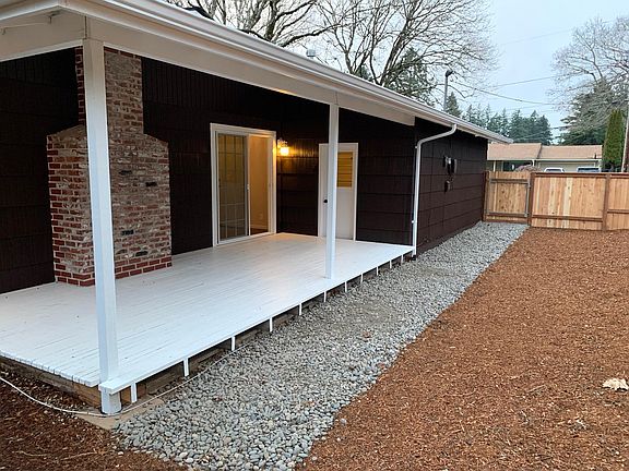 Large covered patio with vaulted ceilings, sits of the dinning room and door to garage. New swing gate with easy access to the yard.