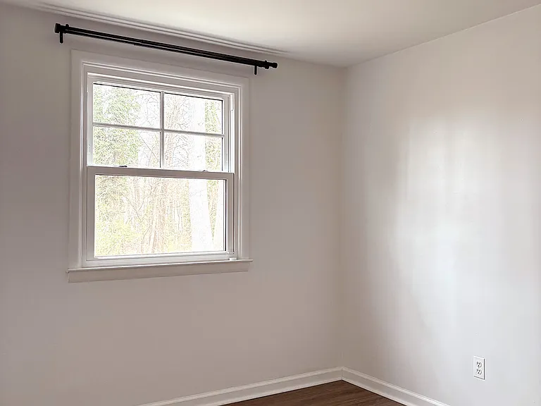 Bottom floor bedroom or office with sliding door closet. Roughly 10x11.