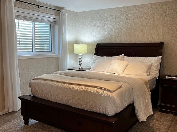 Queen-size bed with large under-bed storage drawers.