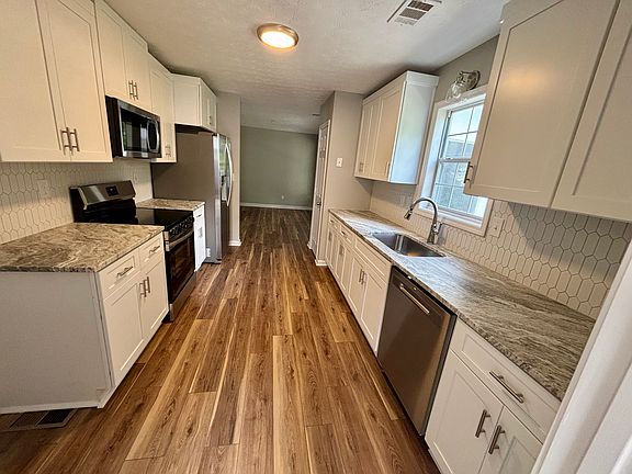 New kitchen stove, microwave, sink, floors