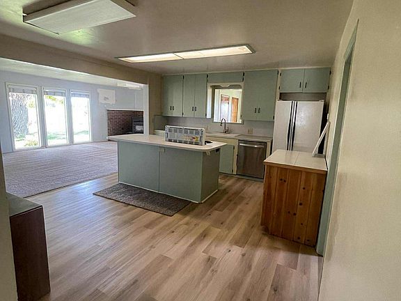 Kitchen and into the living room with pellet stove shown.