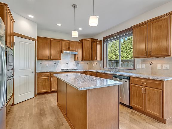 A chef's delight_granite countertops, a double oven, gas range, and a generous island perfect for prepping or entertaining.