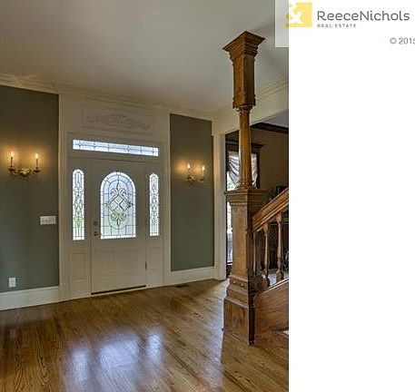 Expansive entry with antique Victorian staircase.