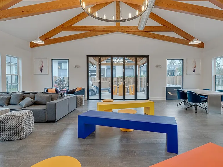 Step into the vibrant common area of Crossings @ 501 Apartments, featuring modern furnishings and a bright, open design perfect for socializing or relaxation. This inviting space is ideal for both work and play. Schedule your visit today!