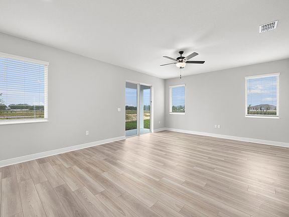 The family room flows seamlessly to the covered back patio by sliding glass doors