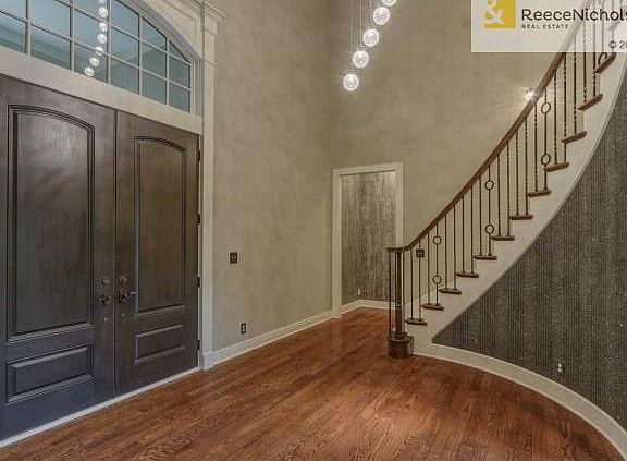 Foyer w/ double door entry and soaring staircase