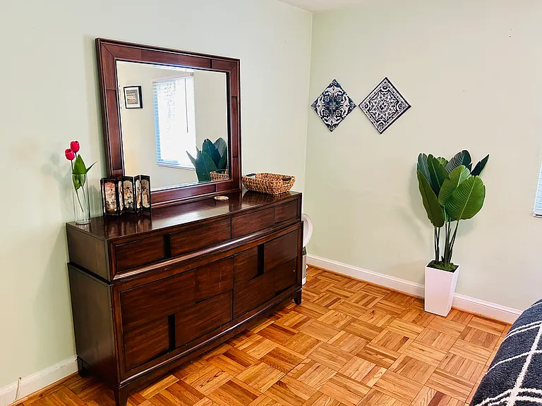Master Bedroom with a King-sized Bed and a large dresser with mirror.