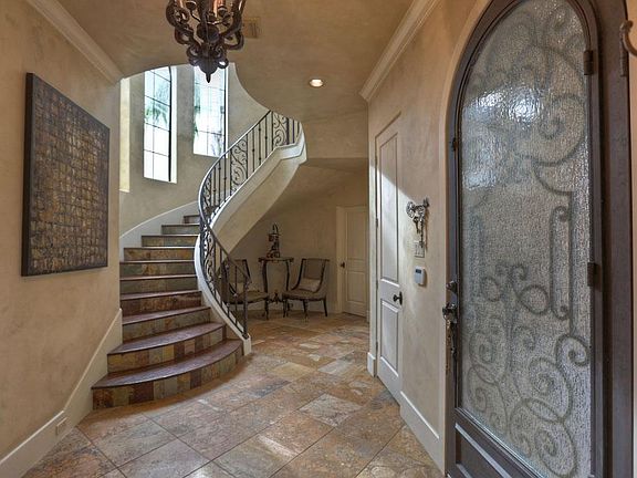 A winding staircase faced with stone and capped with wood treads