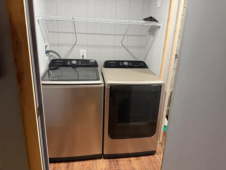 Separate laundry room with Samsung Washer and dryer include and Shark Vacuum cleaner. Lots of storage space.