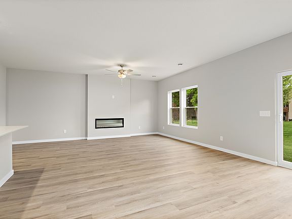 The family room is spacious with a fireplace and ceiling fan.