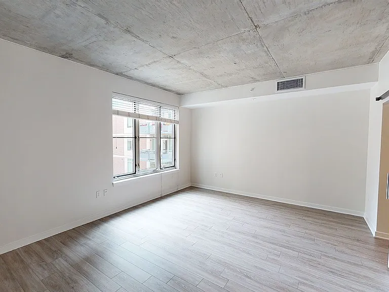 Apartment living room with wood-style flooring.