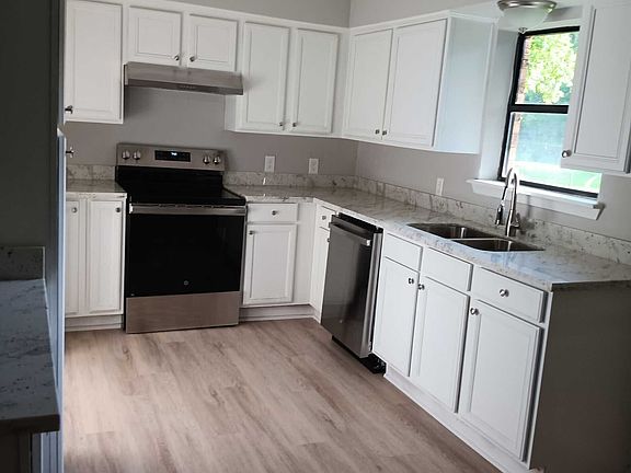 New kitchen. The granite countertops are grey with red speckles throughout. Beautiful! New appliances and clean cabinets.