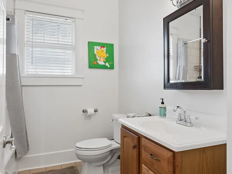 A bright and functional full bath offering comfort, convenience, and easy access from the main-level bedroom.