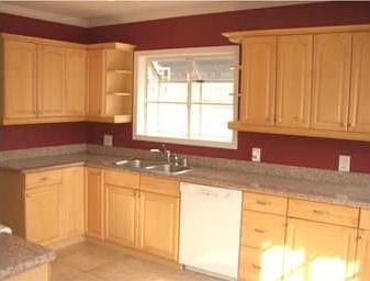 Updated kitchen with granite countertops, garden window and built ins