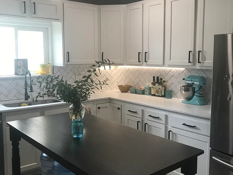 Shaker-style cabinets and subway tiling throughout the kitchen, with large oven & electric cooktop, microwave, dishwasher, ample fridge and freezer, and garbage disposal. Plenty of storage up top and down low includes lazy susan corner cabinet.