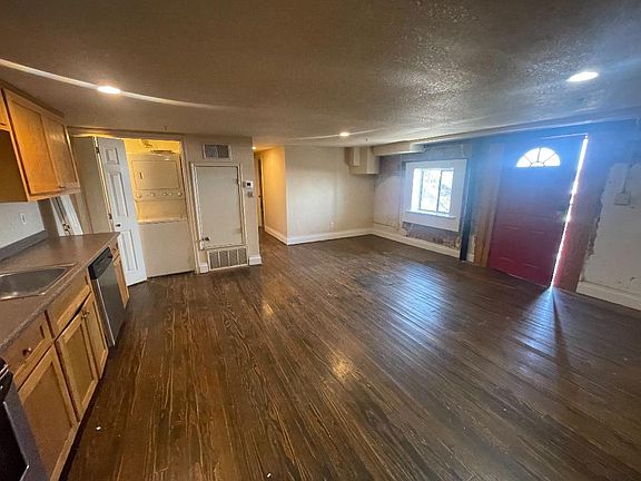 Front Living room, mezzanine level, front door leads to stairs outside.