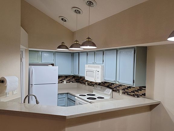 Plenty of counter spaces, with ceiling lights