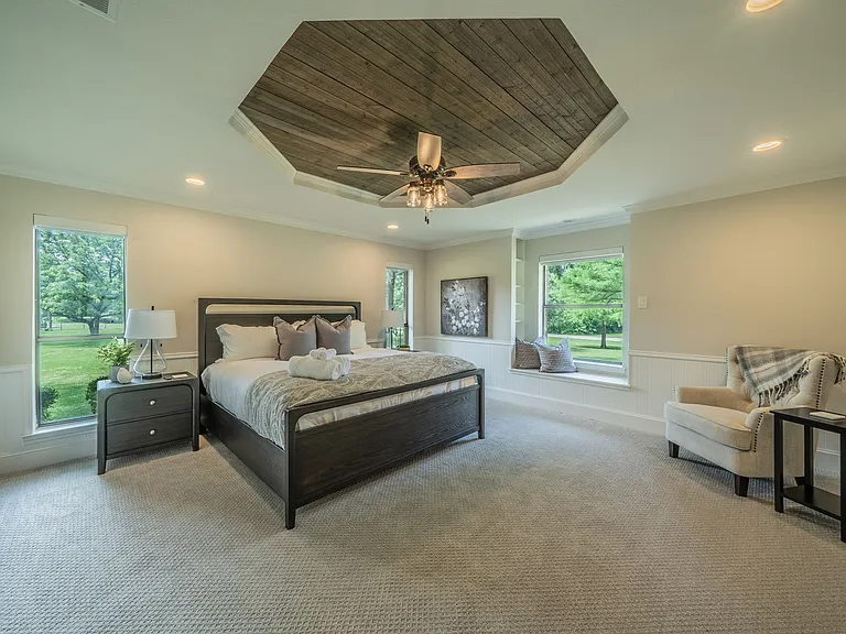 Bedroom 2 Comfort: Large Smart TV, Cozy Armchair & Modern Barn Door Entry