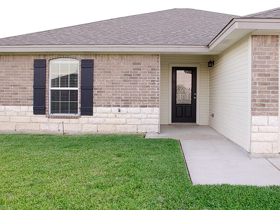 Exterior dark brick over Austin stone