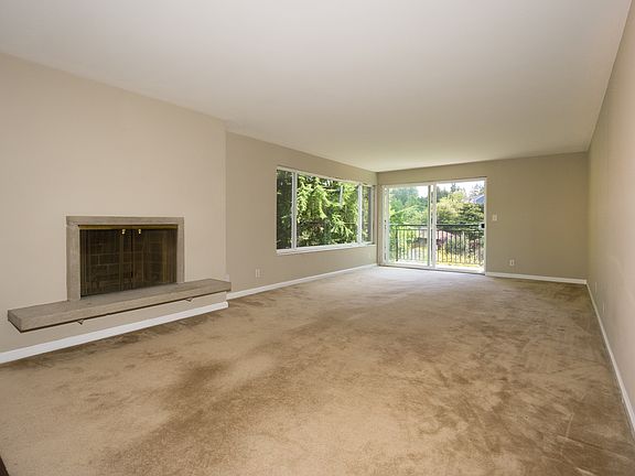 Living Room with Large Windows & Fireplace