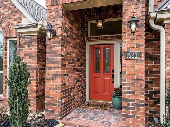 Coach lights and pendant lighting are all a glow beckoning you to step upon the front porch and enter the home.