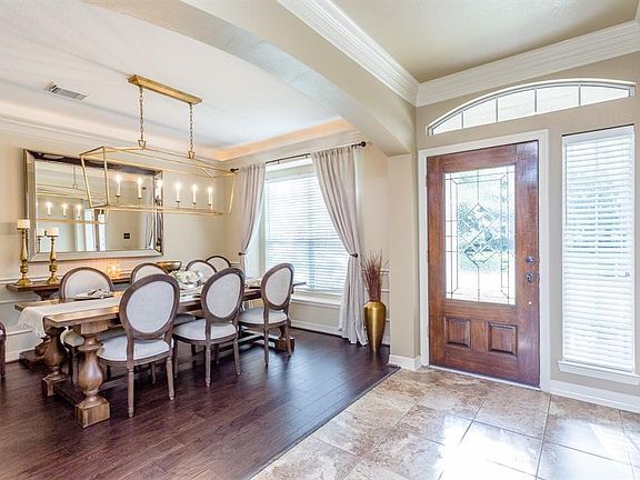 The formal dinning room is just waiting for your family and friends with hard wood flooring this is simply elegant with designer Restoration Hardware chandelier, it's large enough for gatherings yet cozy for daily family dinners.   Uplighting gives an extra luxurious feel to the room.