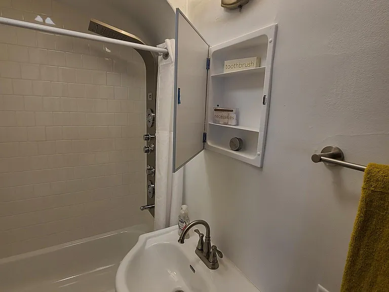 New Bathroom featuring Custom Tile Shower Walls and Flooring with brand new toilet, vanity, medicine cabinet, towel bars, and lighting