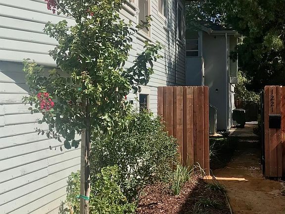 Walkway to private rear yard and quiet off street front porch.