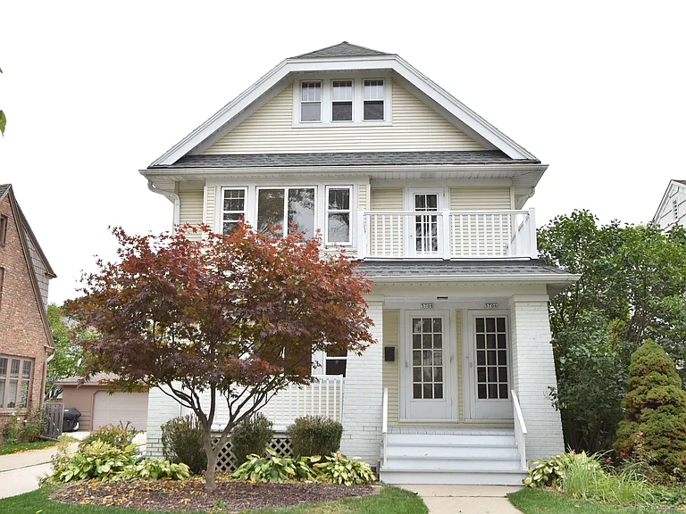 Front of Duplex, beautiful front porch overlooking yard and neighborhood