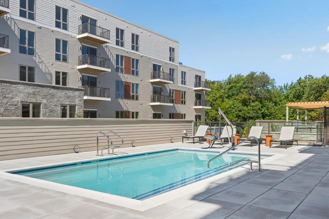 Resort-style pool with sundeck and chaise lounges.