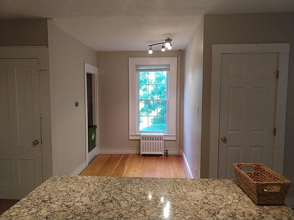 Other side of the kitchen - granite island, basement and bathroom doors