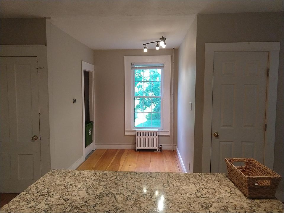 Other side of the kitchen - granite island, basement and bathroom doors