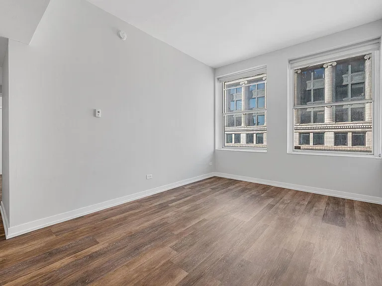 City view from 21st floor bedroom. 12' ceilings, fully remodeled apartments with new flooring, light fixtures and contemporary roller shades covering 8' windows in all apartments.