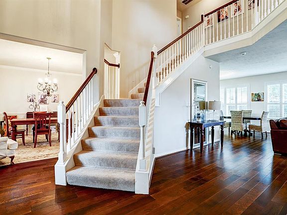 Front entry to the home shows the wood floors, natural light & open-concept layout.