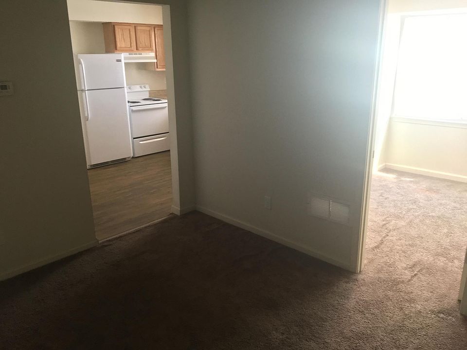 Living room looking into first bedroom and kitchen