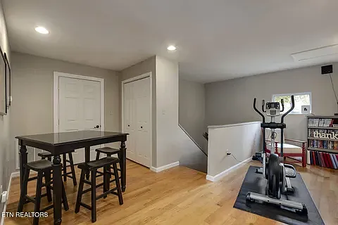 Upstairs den with linen closet and door to walk in attic space - great storage!
