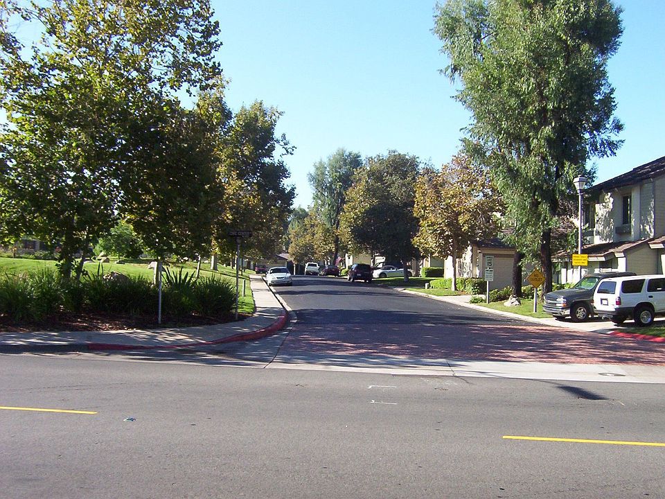 Subdivision entrance home is third building on right.