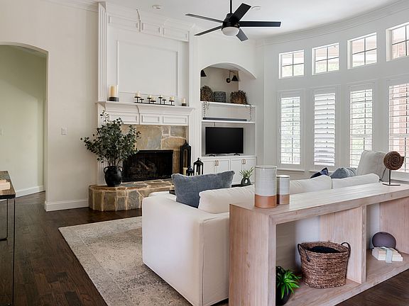 Gas fireplace and shutter window treatments.