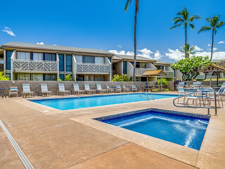 Shared pool and hot tub, along with BBQ area and covered picnic tables.