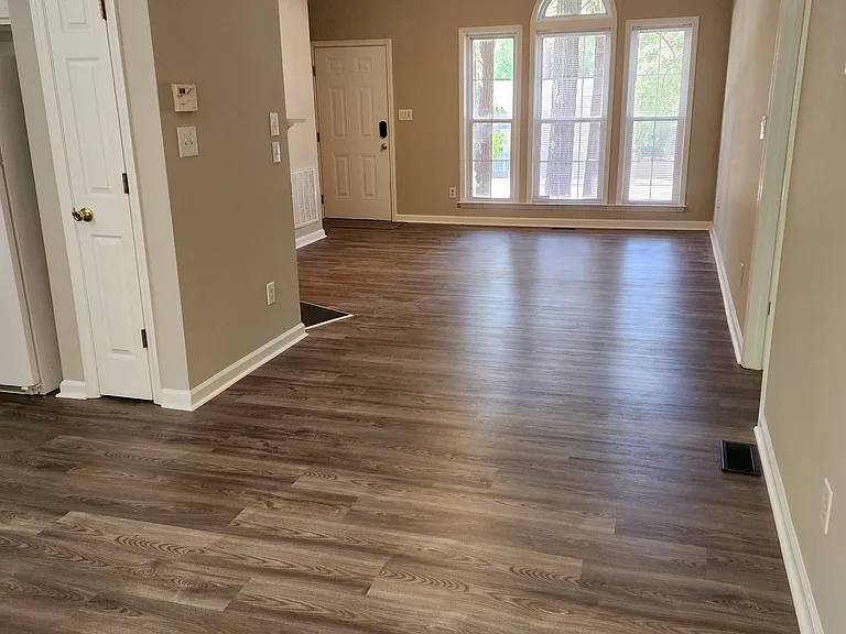 Beautiful big windows. View from dining area into living area.