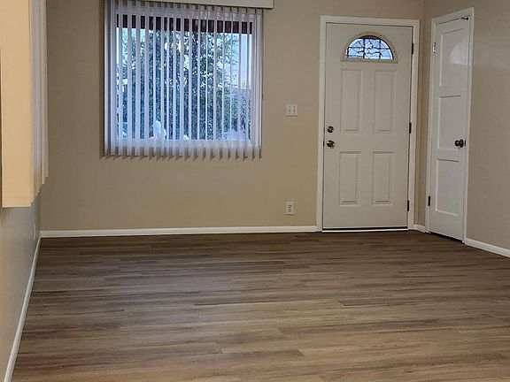 Living room - view from Dining Room.
Large picture window w/Vertical Blinds, Lighted Ceiling Fan and Coat closet