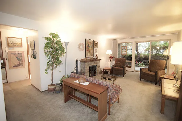 Living room is spacious yet cozy, with a slider to your own private patio area. Ideal for gardening or outdoor enjoyment. Corner unit provides a lot of privacy.